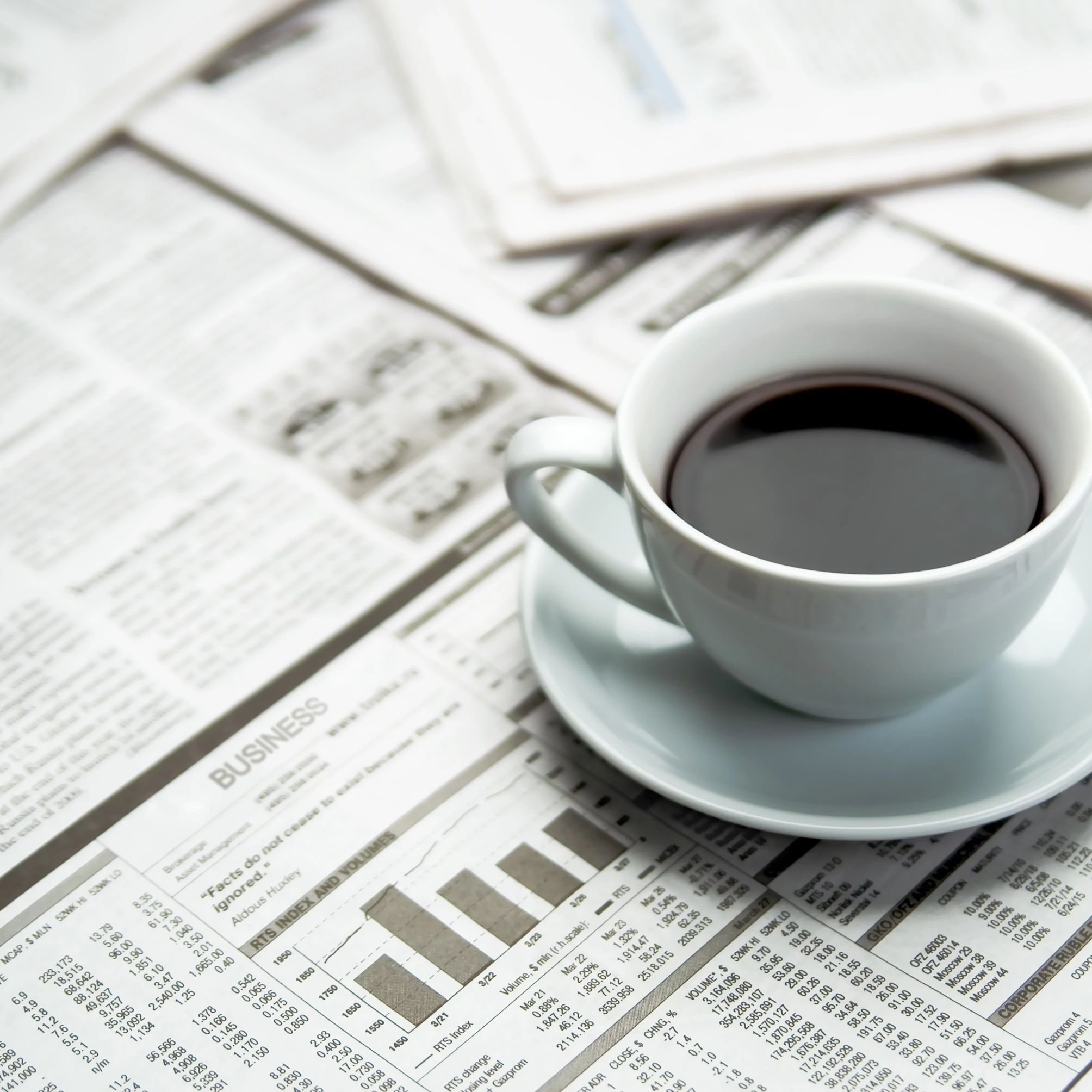 A cup of coffee on the newspaper from Home Floor Covering and Polson Stone and Tile in Polson, MT